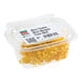 A clear plastic container filled with yellow micro marigold edible flowers.