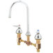 A chrome T&S deck mount faucet with a gooseneck spout and pedal valve connection.