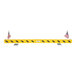 A yellow and black overhead door guard with two American flags attached at each end.