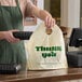 A beige plastic wavetop bag with 'Thank You' printed on it, used for carrying takeout food containers.