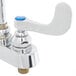 A chrome T&S deck mount faucet with blue wrist action handles.