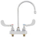 A chrome T&S deck-mount faucet with 4" wrist action handles.