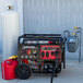 A DuroStar 500 CC Tri Fuel Portable Generator with CO Alert, model DS13000MXT, shown with a propane tank and a red gasoline can.
