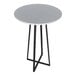 A round white bar height table with a black metal base.