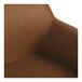 A close-up view of a brown faux leather bench with armrests and a high back.