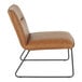 A modern accent chair with camel-colored faux leather upholstery and a black steel frame.