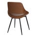 A camel-colored faux leather chair with an open back and black metal legs.