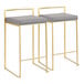 A pair of gold steel counter height stools with gray faux leather seats and low backs.