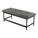 A gray faux leather bench with a tufted seat and a black metal frame.
