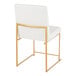 A white faux leather high back side chair with a gold brushed stainless steel frame.