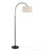 A tall oil bronze metal floor lamp with a curved arm and a natural linen drum shade.