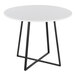 A round white dining table with a black metal base.