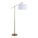 A gold metal floor lamp with an off-white linen drum shade.