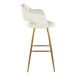A barstool with a cream faux leather bucket seat, armrests, and gold metal legs.