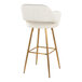 A barstool with a cream faux leather bucket seat, armrests, and gold metal legs.