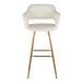A barstool with a cream faux leather bucket seat, armrests, and gold metal legs.