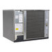 A commercial air-cooled ice machine unit with a metal exterior and visible condenser coils.