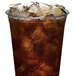 A clear plastic cup filled with dark soda and ice cubes.