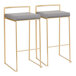 A pair of gold steel barstools with low backs and gray faux leather seats.