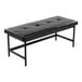A black faux leather bench with a tufted cushion and a black metal frame.