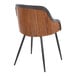 A modern arm chair with a walnut wood back, brown faux leather upholstery, and black metal legs.