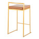 A modern counter height stool with a gold steel frame and a camel faux leather seat.