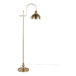 A gold metal floor lamp with a dome-shaped shade and a curved arm design.