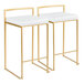 A pair of gold metal counter height stools with low backs and white faux leather seats.