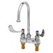 A chrome T&S deck mount medical faucet with 4" wrist action handles.