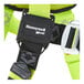 A close-up view of a Honeywell Miller H500 green full-body safety harness with tongue leg buckles.