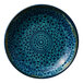 A round deep porcelain coupe plate with a blue rim and intricate blue patterned design.