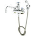 A T&amp;S deck-mount faucet with angled spray valve and hose.
