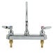 A chrome T&S deck mount faucet with two handles and a 14" swing nozzle.