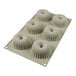 A silicone baking mold with six ridged donut-shaped cavities.