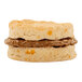 A sausage and sharp cheddar cheese biscuit breakfast sandwich.