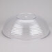 A large clear ribbed plastic bowl turned upside down.