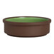 A round, brown stoneware tray with a green interior, designed to be stackable and deep, measuring 4 inches in diameter.