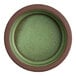 A small round green and brown stoneware tray.