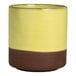 A round stoneware cup with a yellow upper half and a brown lower half.