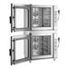 A double-stacked set of stainless steel half size electric combi ovens with manual controls and glass doors, designed to hold six pans each.