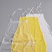 A set of three vinyl dishwasher aprons in clear, yellow, and white colors, each with white neck and waist ties.