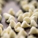 A pile of Nestle Toll House Premier White chocolate morsels.