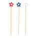 A set of three bamboo cocktail picks with red, blue, and white star-shaped tops.