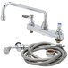 A T&S chrome deck-mount workboard faucet with a hose and spray valve.