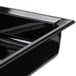 A black Vollrath plastic food pan on a counter.