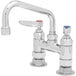 A T&S chrome deck-mount sink faucet with two blue handles.