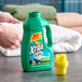 A green bottle of XTRA Ultra Mountain Rain liquid laundry detergent with a yellow cap, labeled for 15 loads.