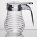 A glass syrup dispenser with a beehive design and a chrome-plated ABS top and handle.