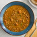 A bowl of Moroccan inspired lentil soup with visible lentils and vegetables.