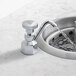 A T&S B-2282-F03 Flow Control faucet running water into a sink.